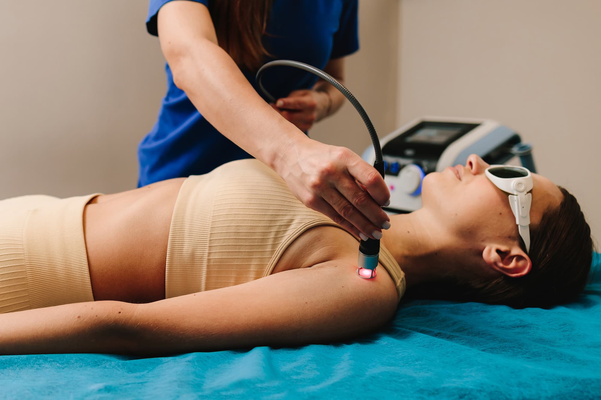a woman getting a laser therapy treatment by a professional chiropractor in Montana a woman getting a laser therapy treatment by a professional chiropractor in Montana