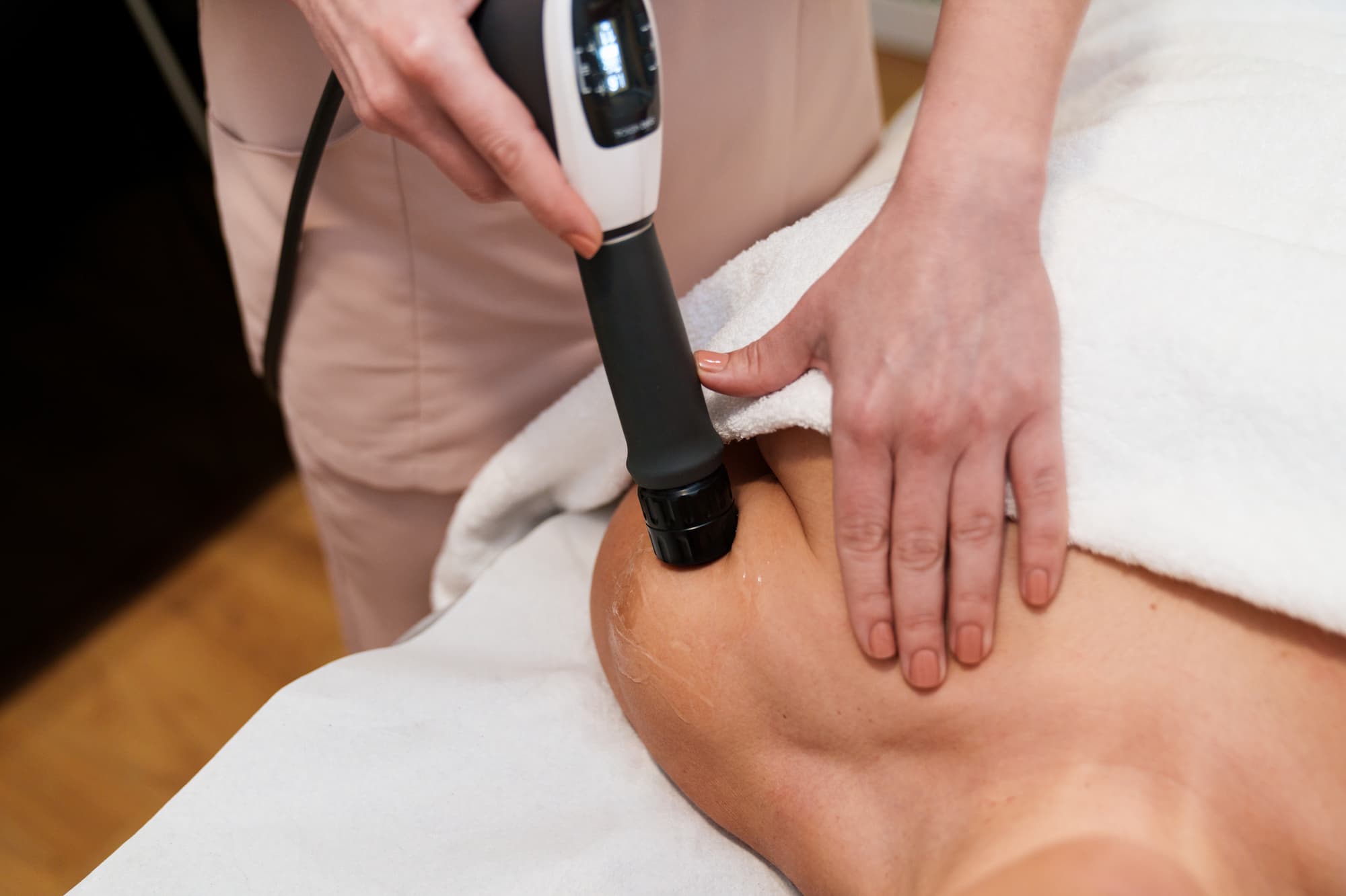 Chiropractor applying shockwave therapy to a patient’s shoulder for pain relief at Whitefish Chiropractic Chiropractor applying shockwave therapy to a patient's shoulder for pain relief at Whitefish Chiropractic
